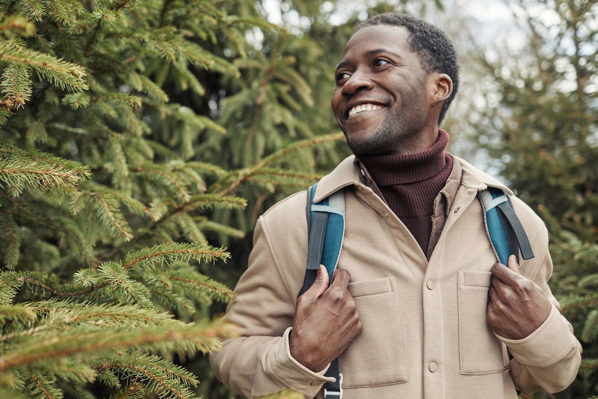 African man hiking among trees