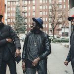three african men greeting in the street